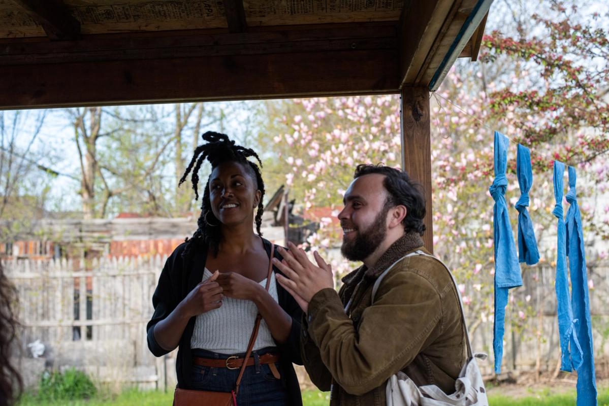 a man and a woman are standing under a canopy .