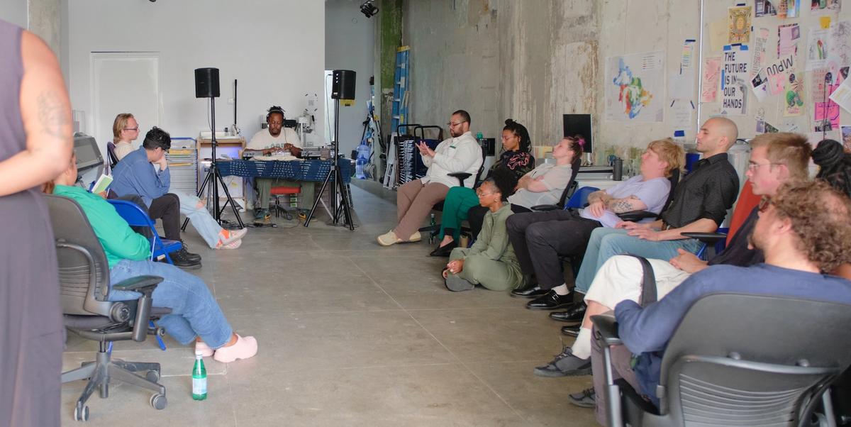 a group of people are sitting in chairs in a room .
