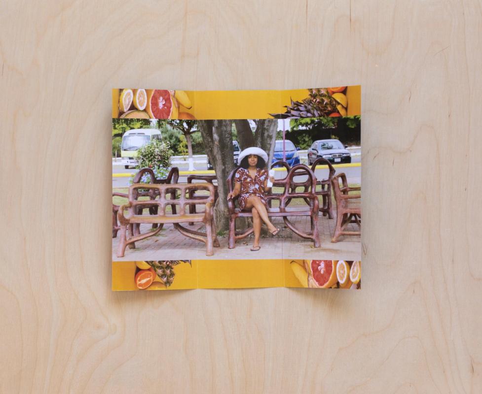 a picture of a woman sitting on a bench on a wooden table .