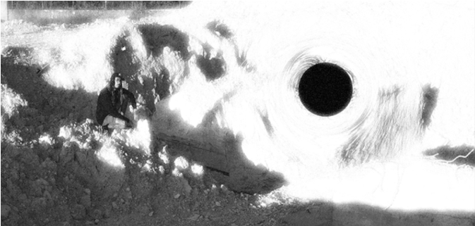 a black and white photo of a black hole in the ground