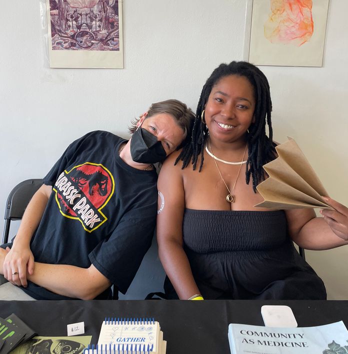 a man wearing a jurassic park shirt sits next to a woman