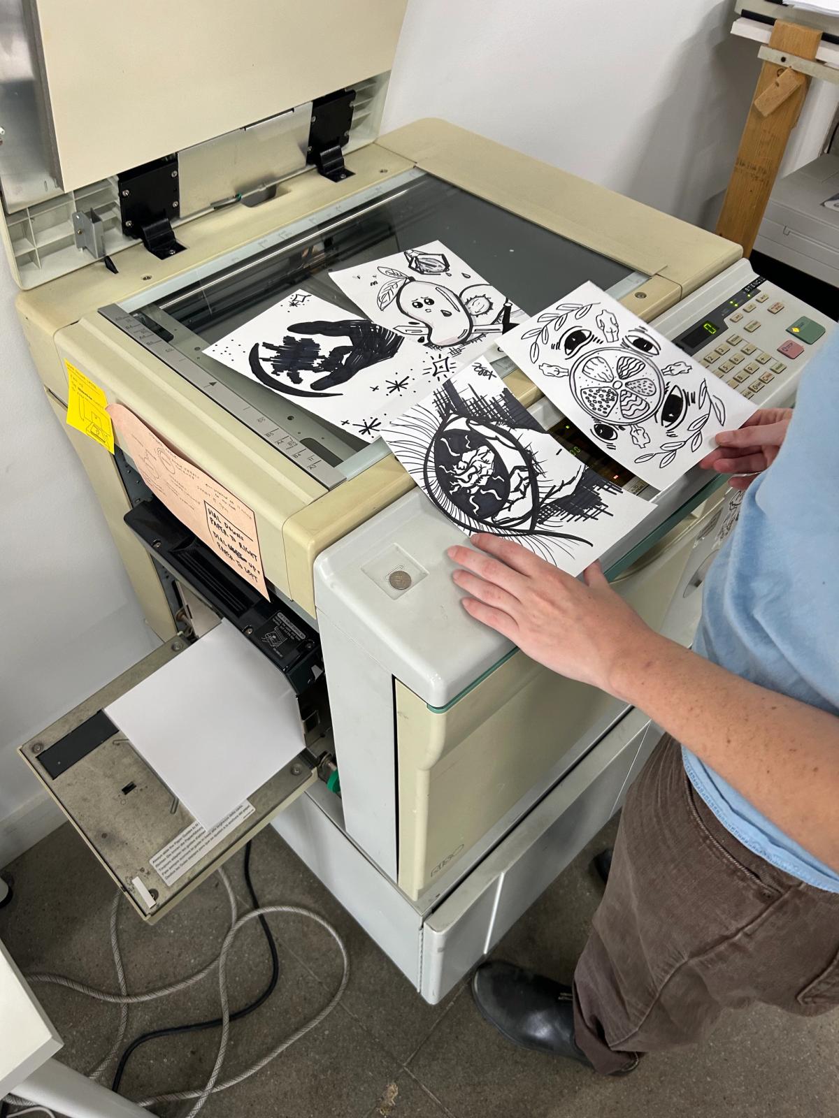 a person is using a copier with a sticker on it that says " do not touch "