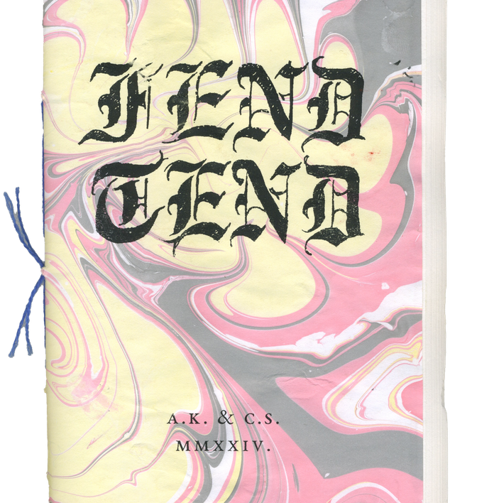 A book with a yellow, pink, gray, and white marbled cover featuring "TEND TEND" in black Gothic script, by A.K. & C.S., 2024, and bound with blue string.