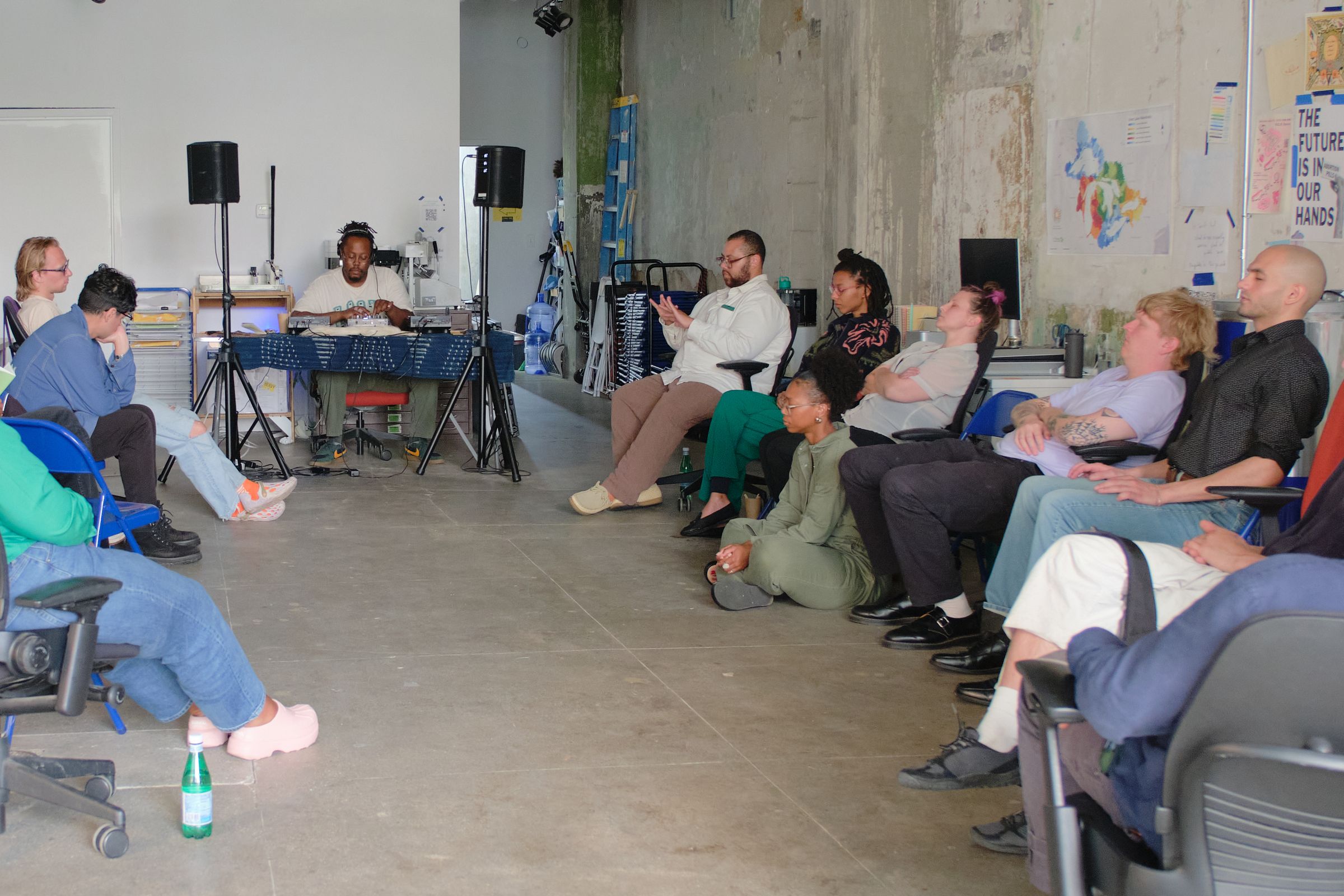 a group of people are sitting in chairs in a room .