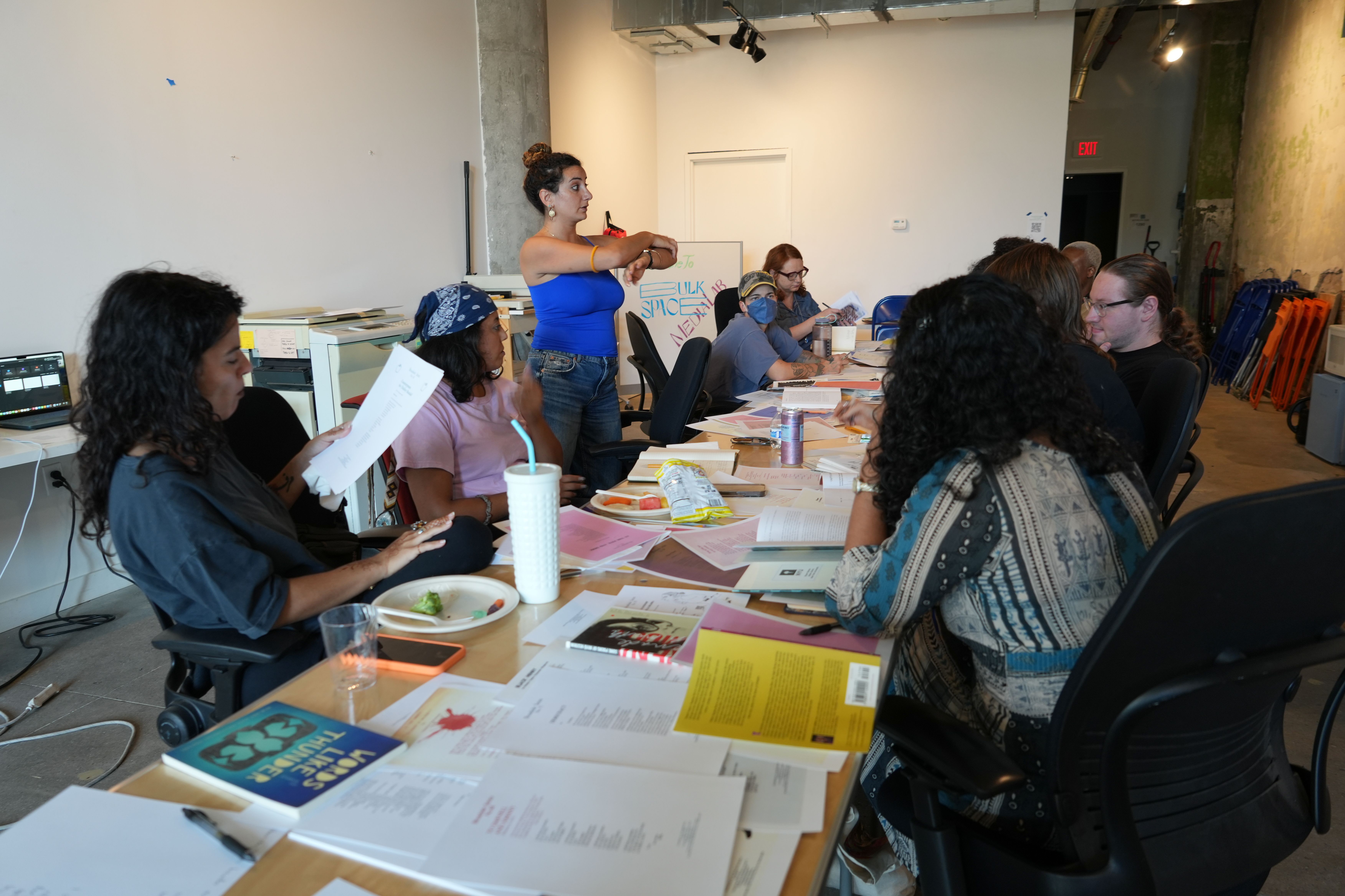 a group of people are sitting around a table in a room .