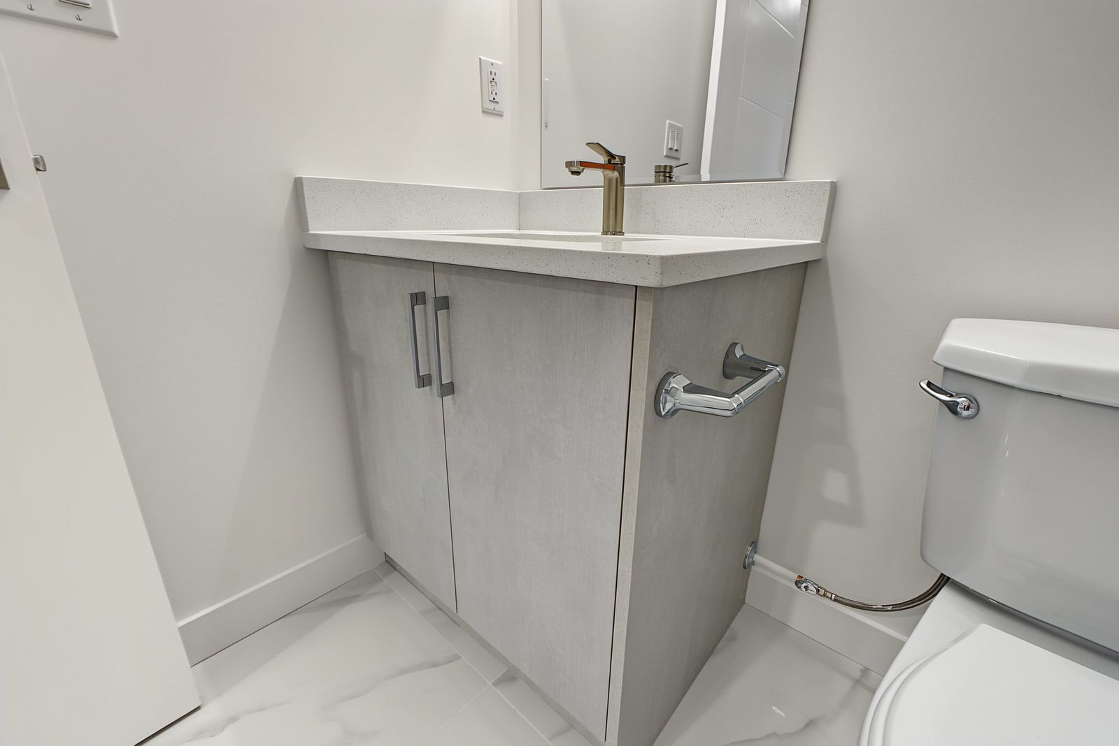 Vanity and toilet from the bathroom door