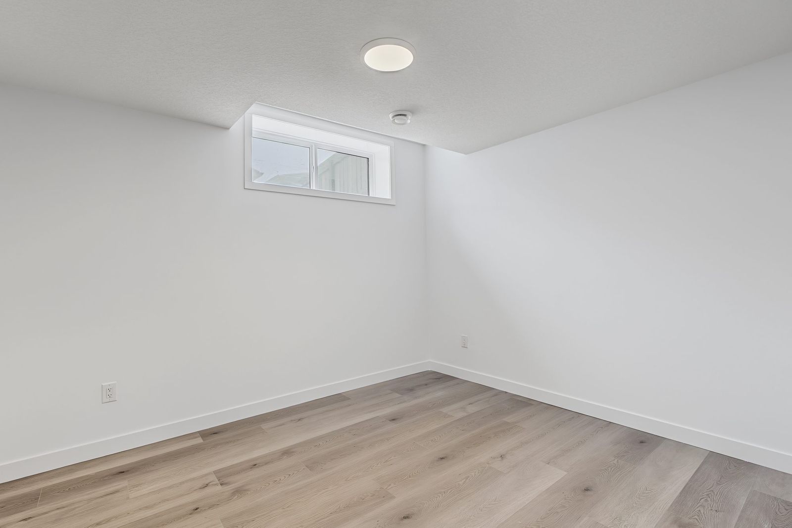 Bedroom corner with the egress window and pot light