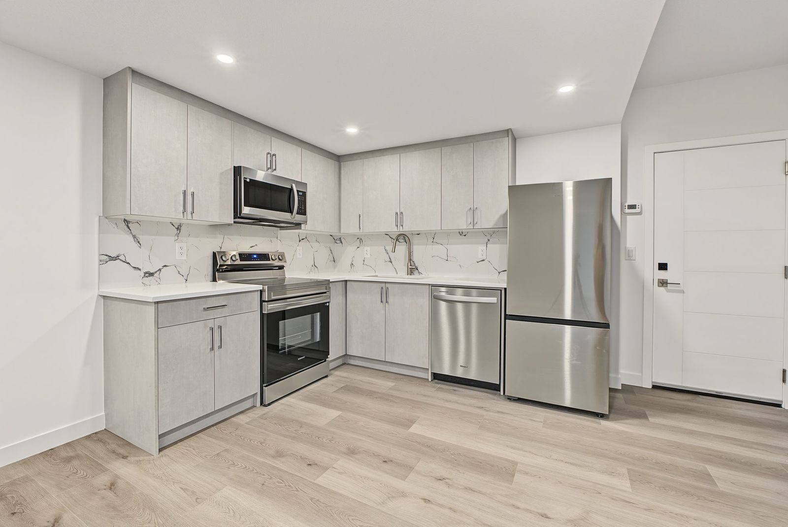 Suite kitchen, wide view toward the entry door