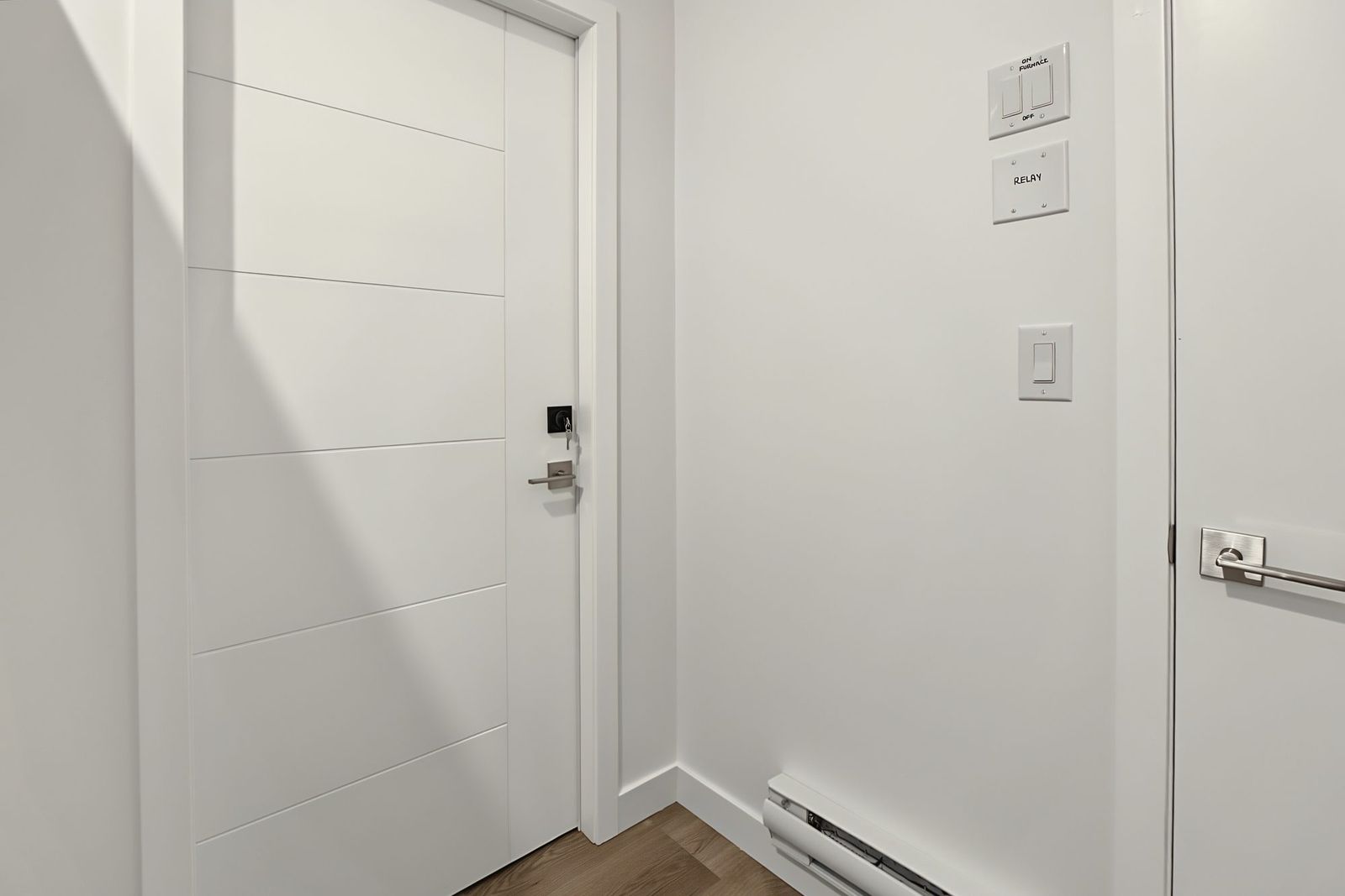 The suite's entry door with its own light switches