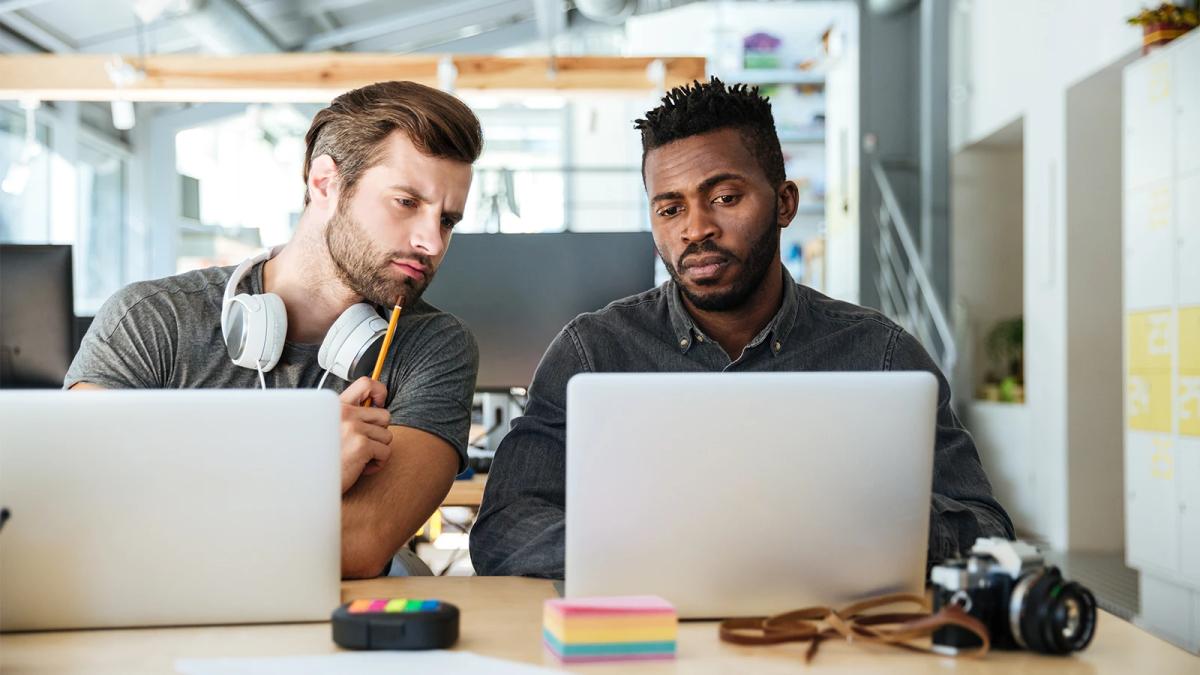 Web designer reviewing a custom website build on a laptop for a Caribbean business