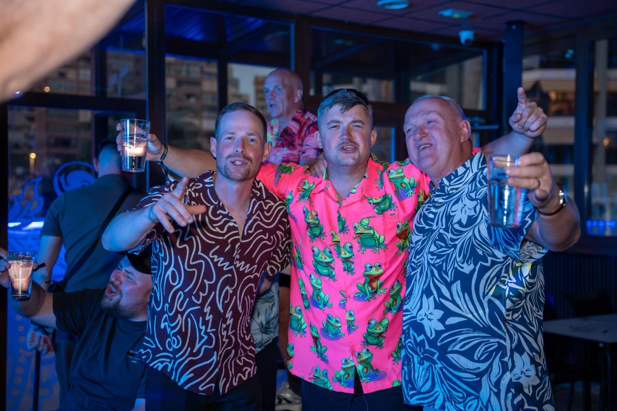 A stag group in party shirts celebrating at Rockstar Benidorm