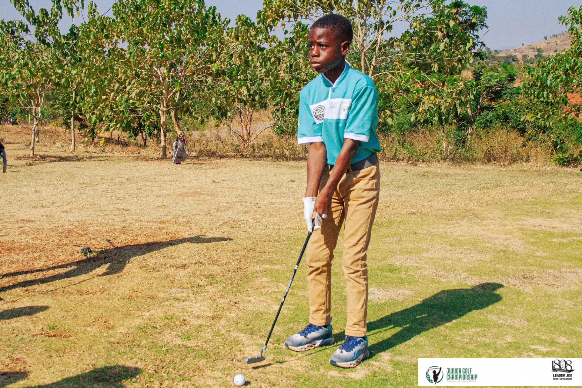 Black kid playing golf