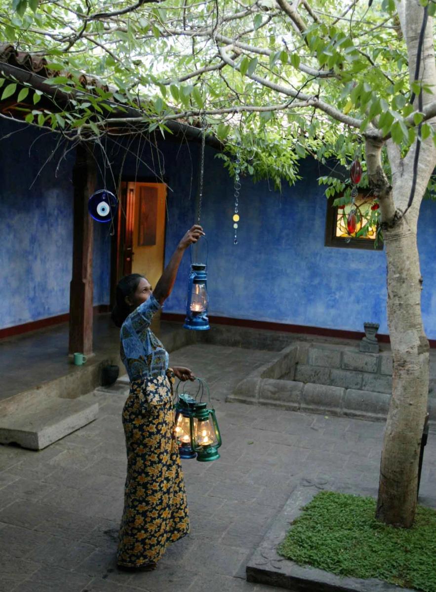 Lighting the lamps in the courtyard at Ulpotha
