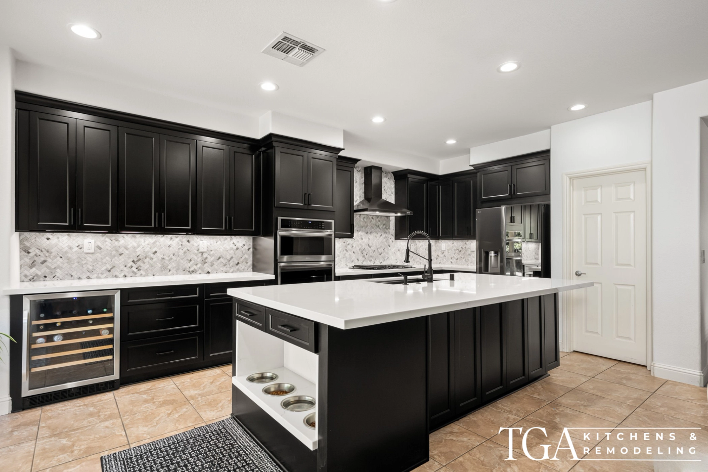 Remodeled Tampa kitchen with black shaker cabinets, white counters, and a large island