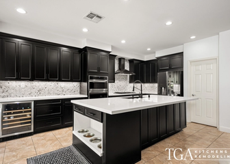 Remodeled Tampa kitchen with black shaker cabinets, white counters, and a large island