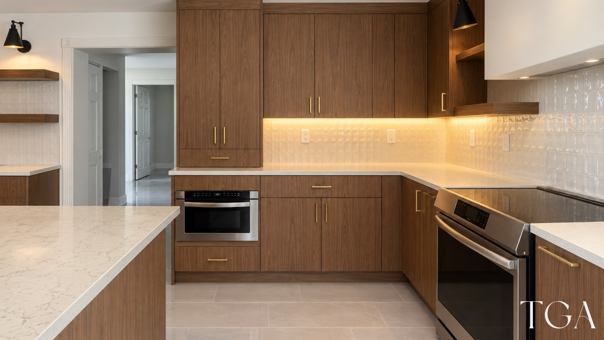 Walnut kitchen cabinetry with light counters, a built-in microwave and warm under-cabinet lighting