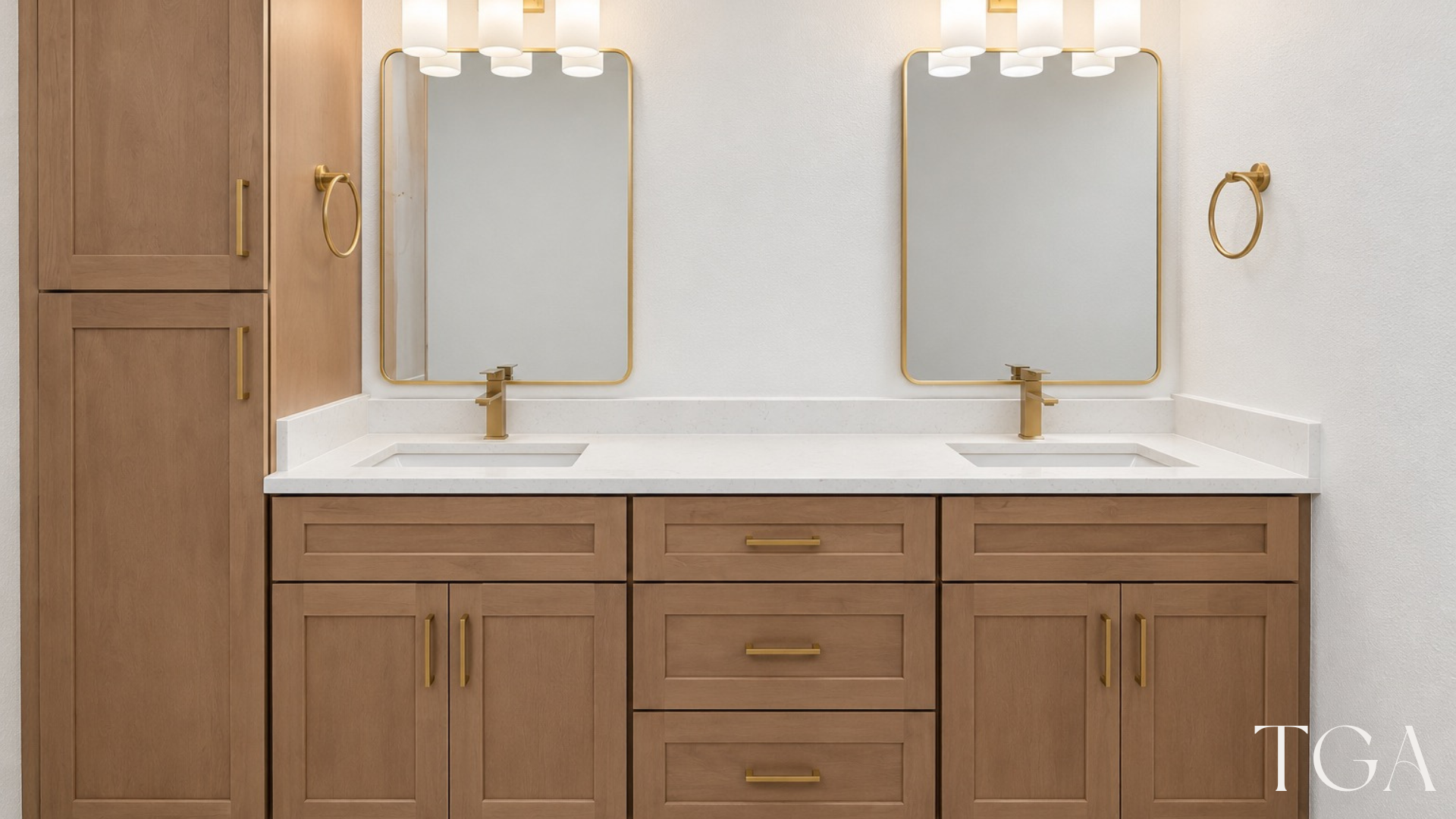 Wood-tone double vanity with brushed gold faucets, framed mirrors and a matching tall cabinet in St. Petersburg.