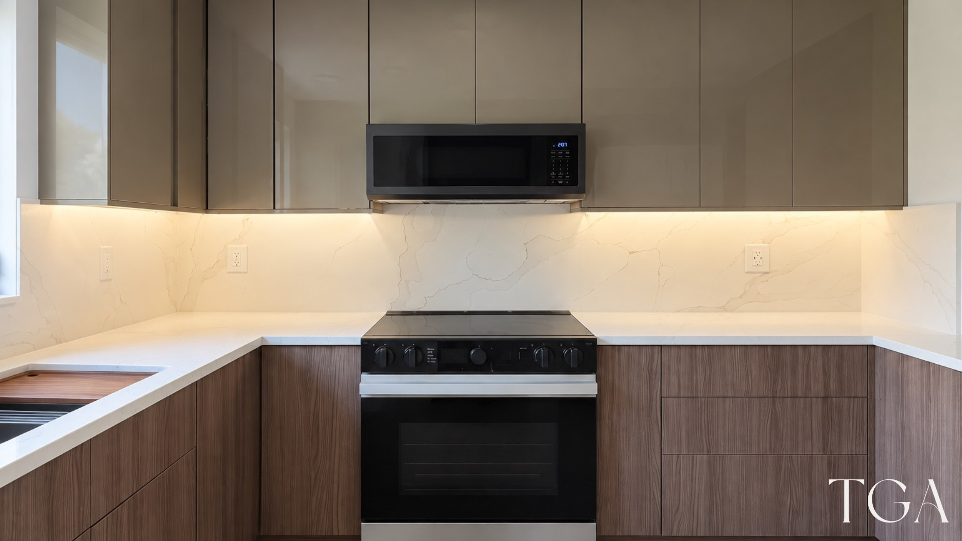 Completed cooking wall with range, microwave, taupe cabinets and illuminated veined backsplash