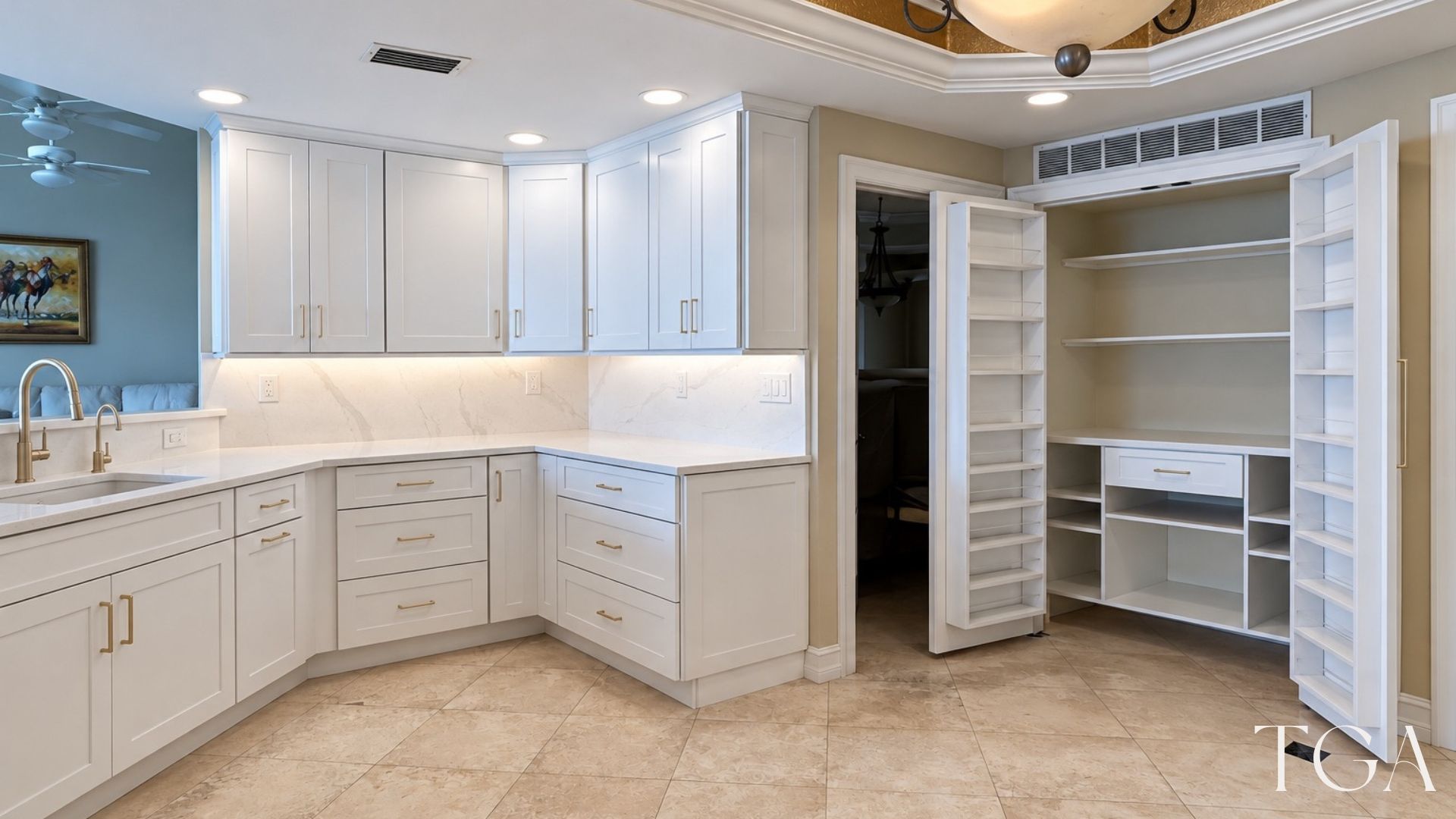 White kitchen and open custom pantry with shelving, a central drawer and storage racks on the doors