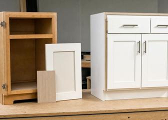 Retained cabinet box and new door sample beside a complete replacement cabinet
