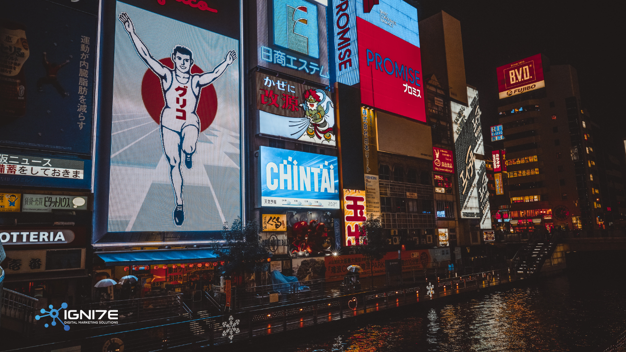 Glico Man neon sign and bright advertisements reflecting on the Dotonbori river at night