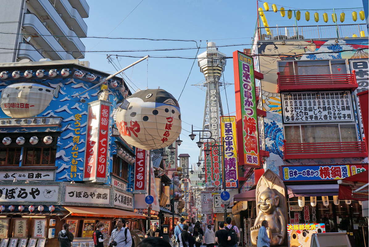 Tsutenkaku Tower and giant pufferfish lantern in the vibrant Shinsekai district of Osaka