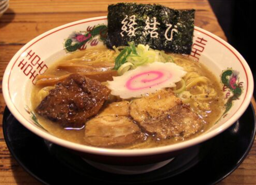 Ramen bowl with chashu pork, narutomaki fish cake, and seaweed with Japanese characters