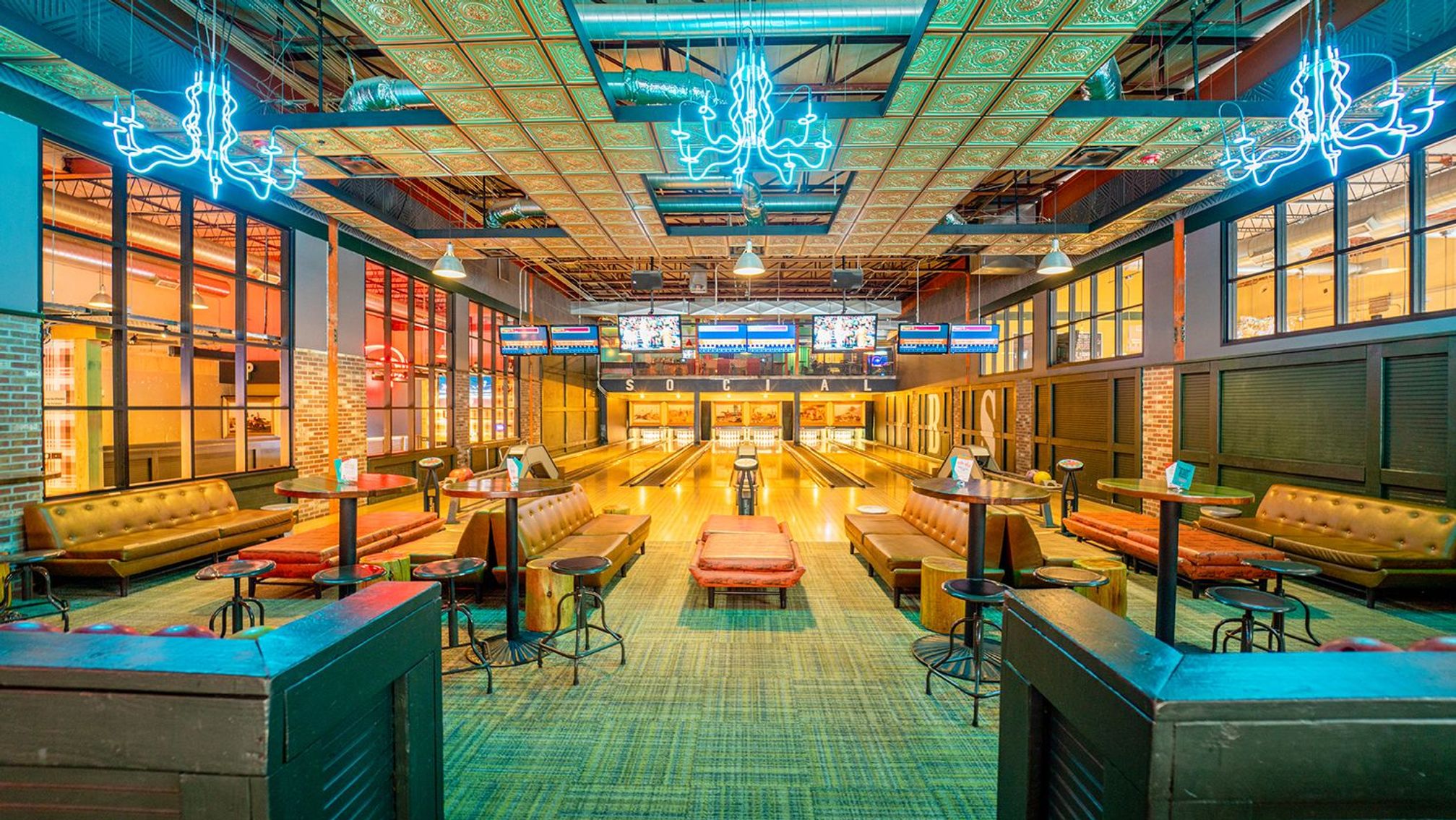 Punch Bowl Social bowling lanes interior with neon chandeliers and lounge seating