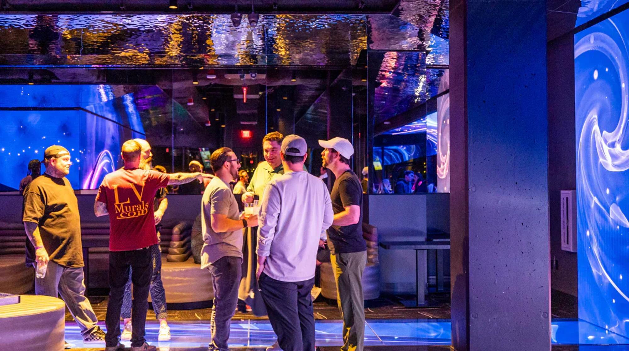 Guests socializing and enjoying drinks at Atomic Golf in Las Vegas