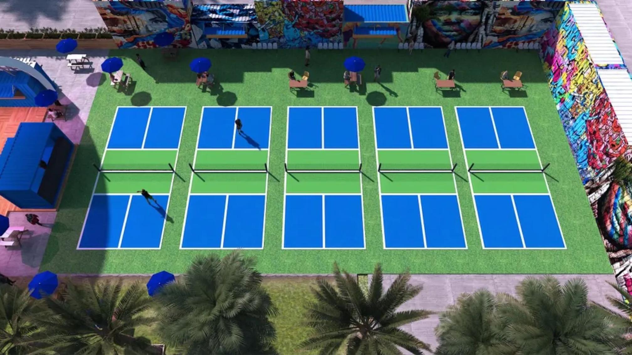 Aerial view of an outdoor pickleball facility with five courts and graffiti walls