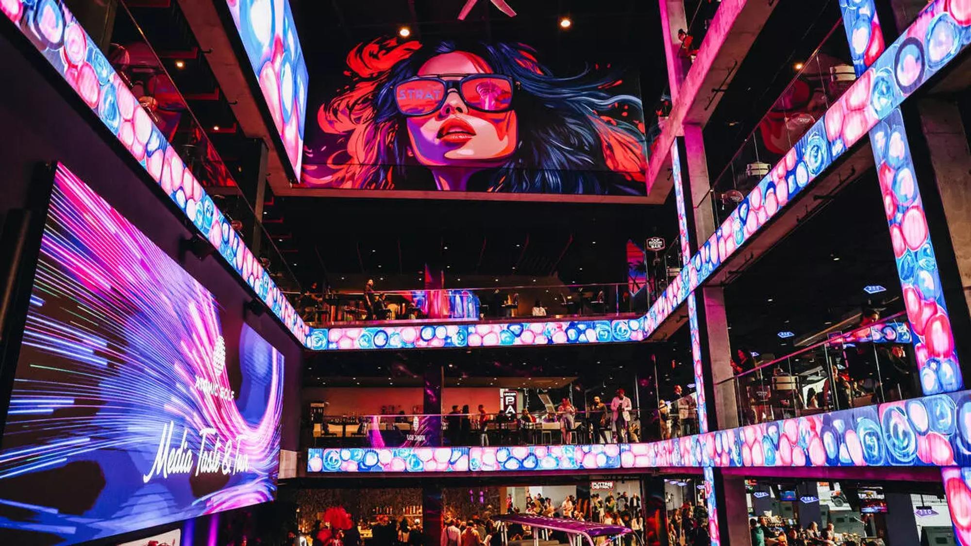 Atomic Golf multi-level venue interior with LED screens and neon lighting on the Las Vegas Strip