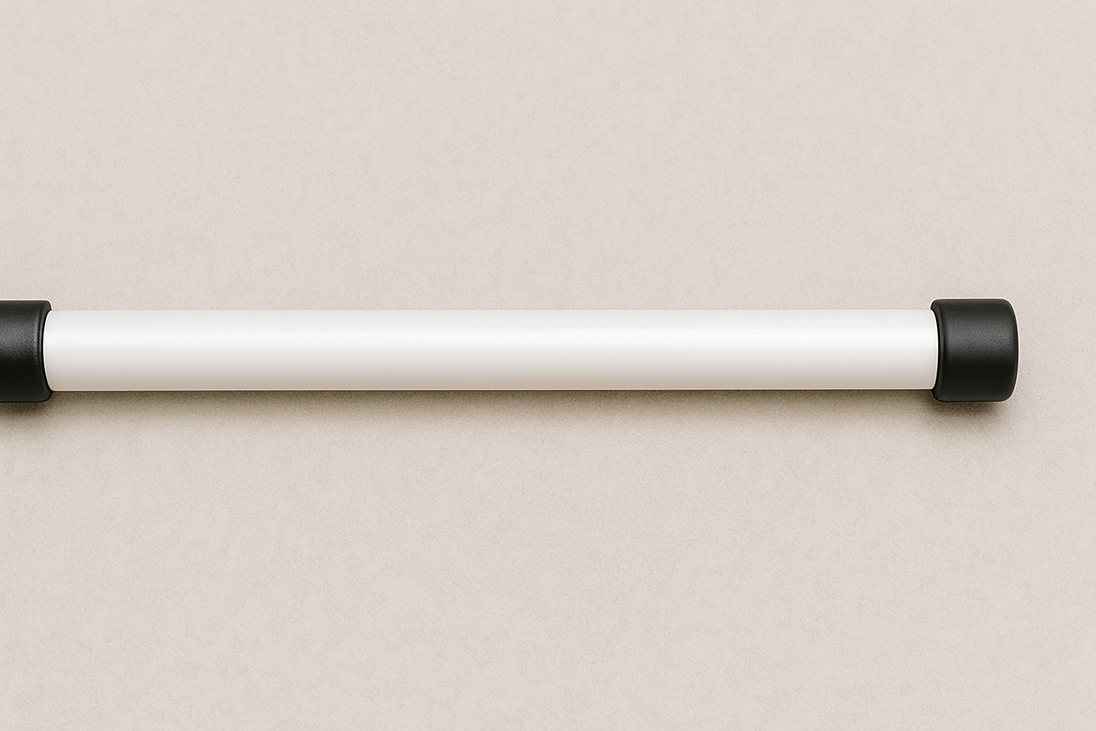 a white tube with black ends is against a beige wall