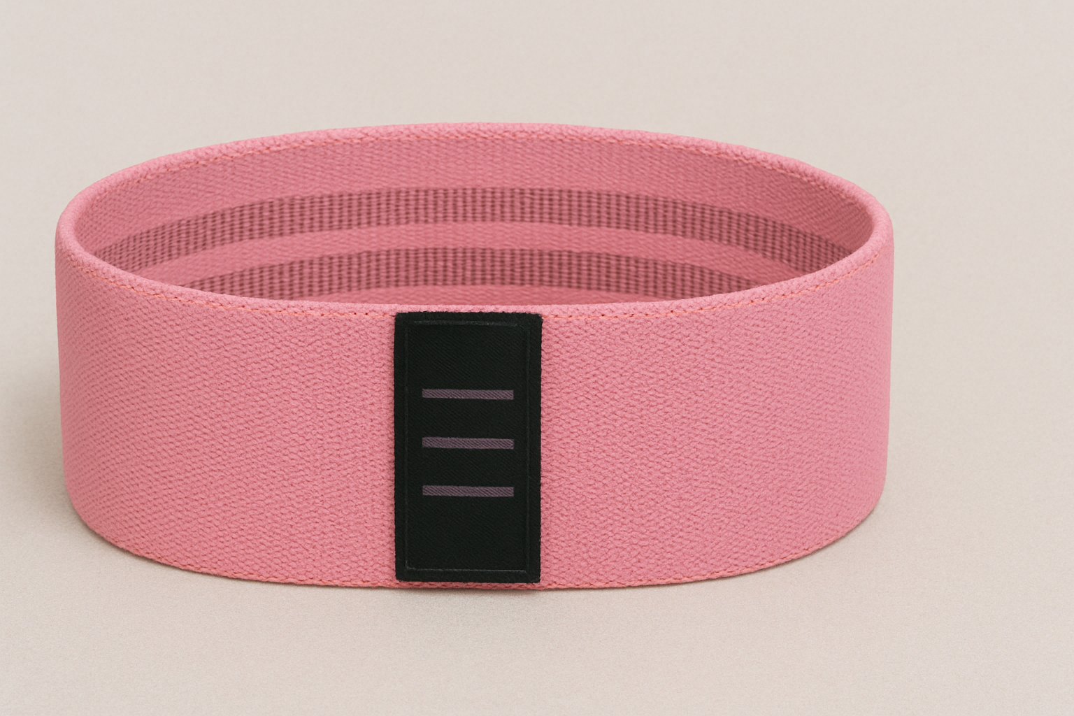 a pink resistance band with a black stripe on the side