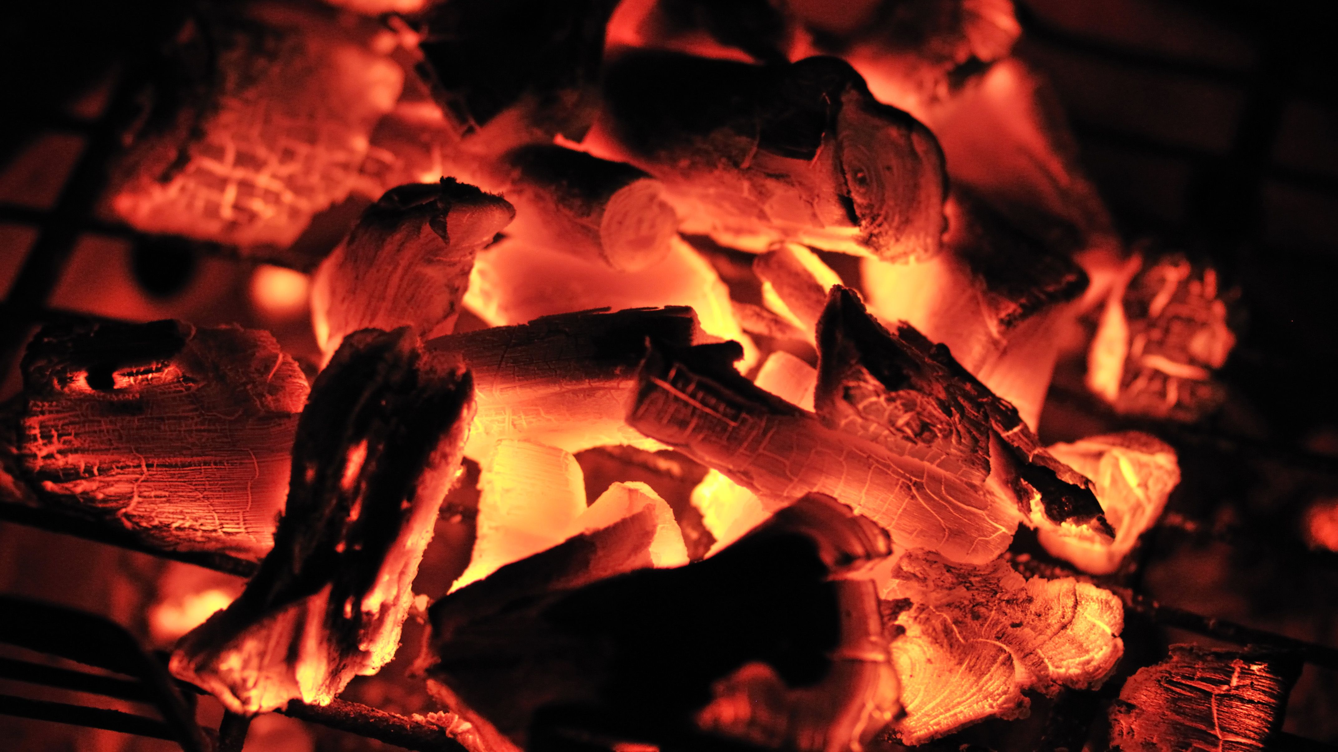 Burning charcoal briquettes with visible ash residue