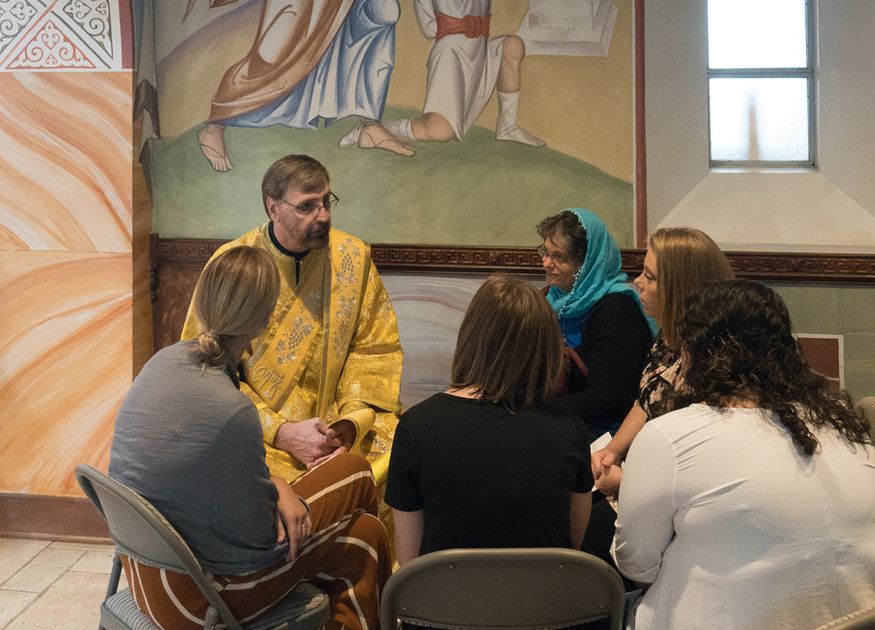 Church deacon and women sitting down to talk