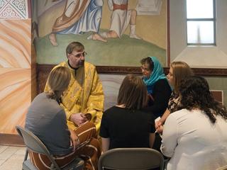 Church deacon and women sitting down to talk