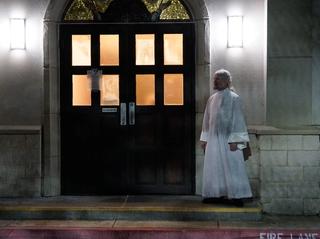 Protodeacon Brendan waits at the door to usher in the congregation as the complete the procession