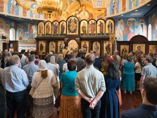 Orthodox congregation standing in attendance at Divine Liturgy 