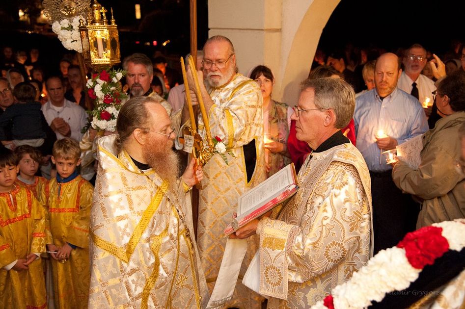 Preist reads the gospel following candlelight procession around the cathedral. 