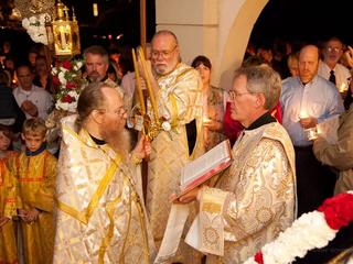 Preist reads the gospel following candlelight procession around the cathedral. 