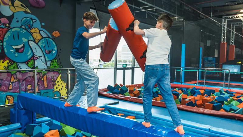 Kids jumping on trampolines at an indoor activity park in Kuwait