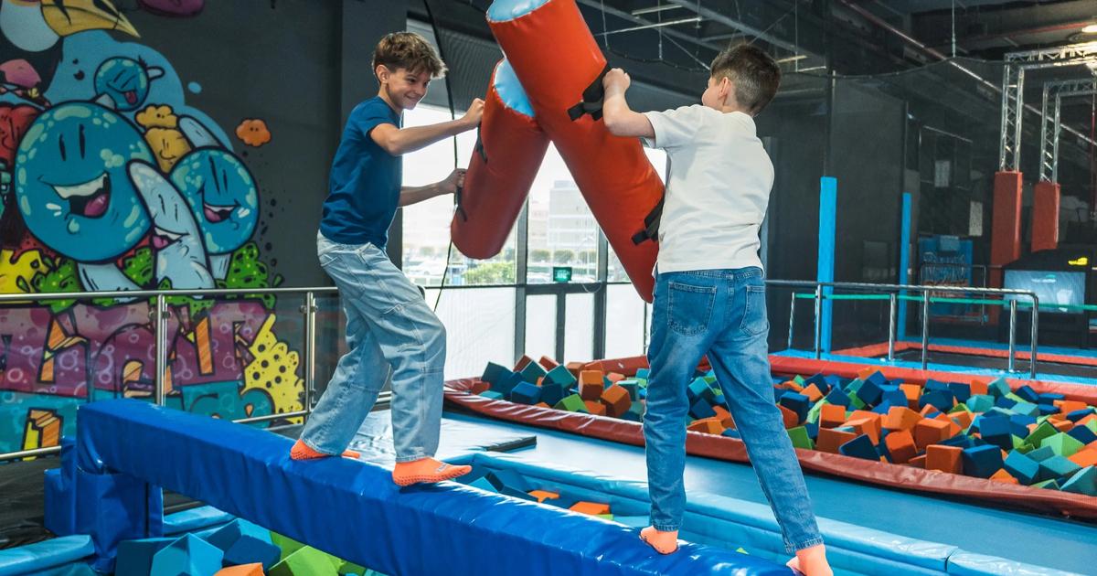 Kids jumping on trampolines at an indoor activity park in Kuwait