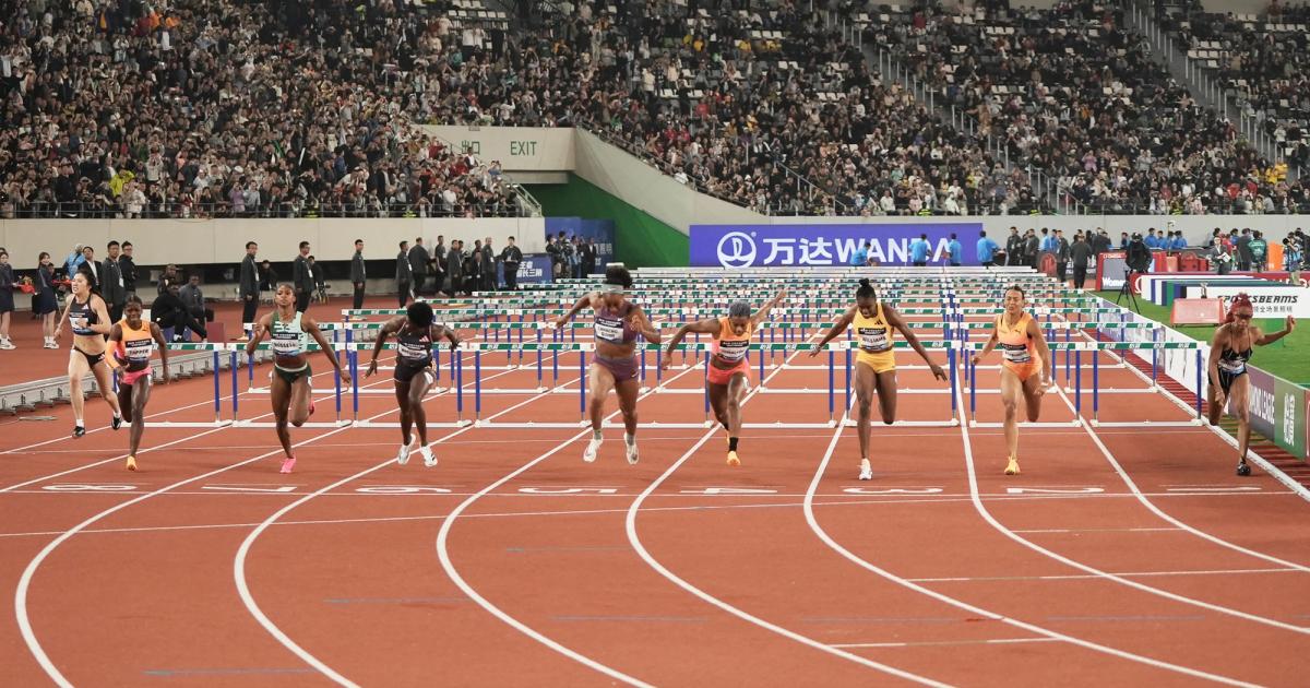 Women's 100m hurdles finish at the Shnaghai Diamond League with a big crowd.