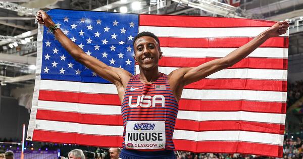 Yared Nuguse holding the USA flag after his runner-up finish at the World Athletics Indoor Championships.