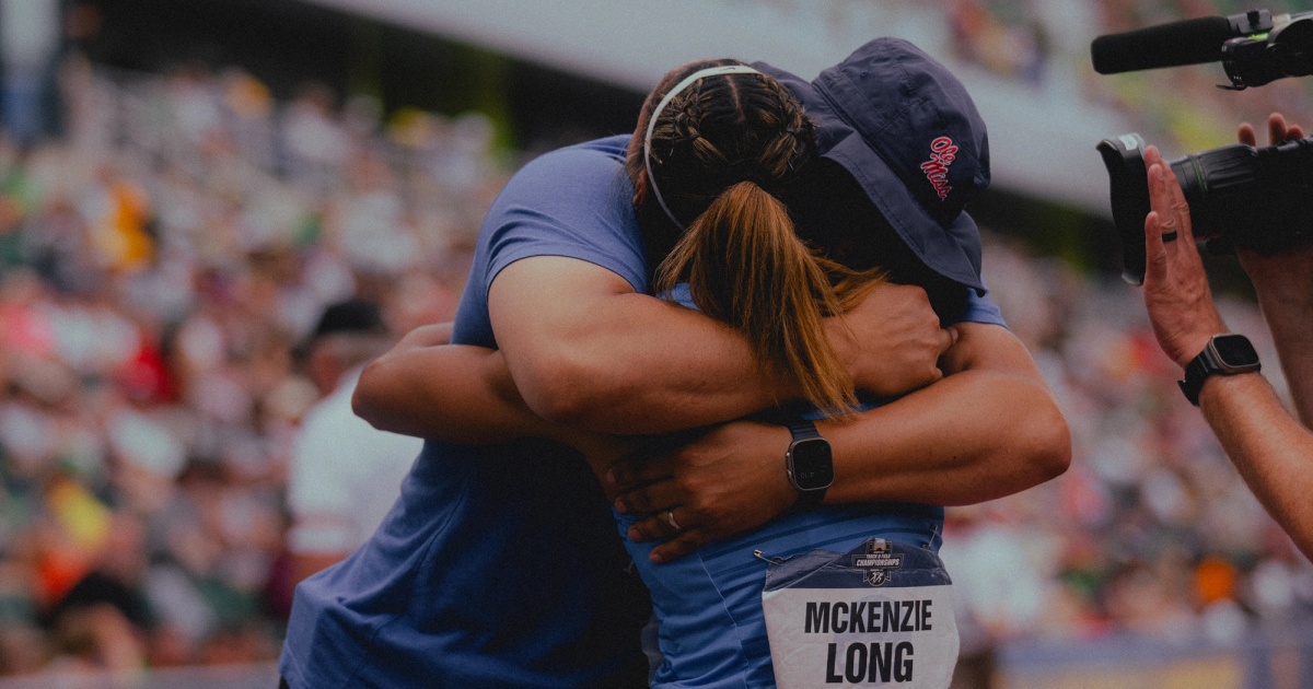 McKenzie Long hugs her dad after winning the NCAA 200m title.