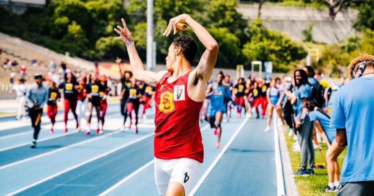 USC's anchor celebrates across the finish line ahead of UCLA at the USC vs. UCLA dual meet