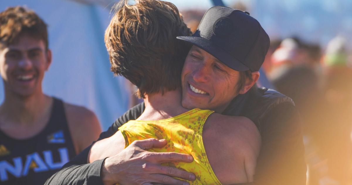 Mike Smith celebrates winning the 2022 NCAA Cross Country Championship men's team title.