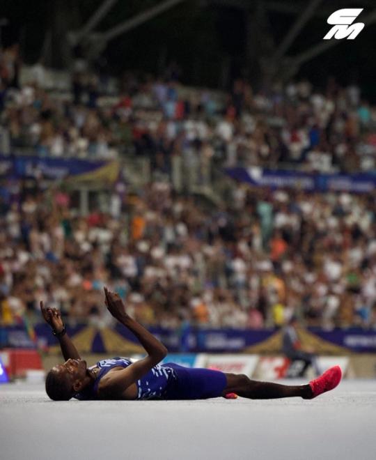 Lamecha Girma lays on the track after breaking the steeplechase world record at the Paris Diamond League.