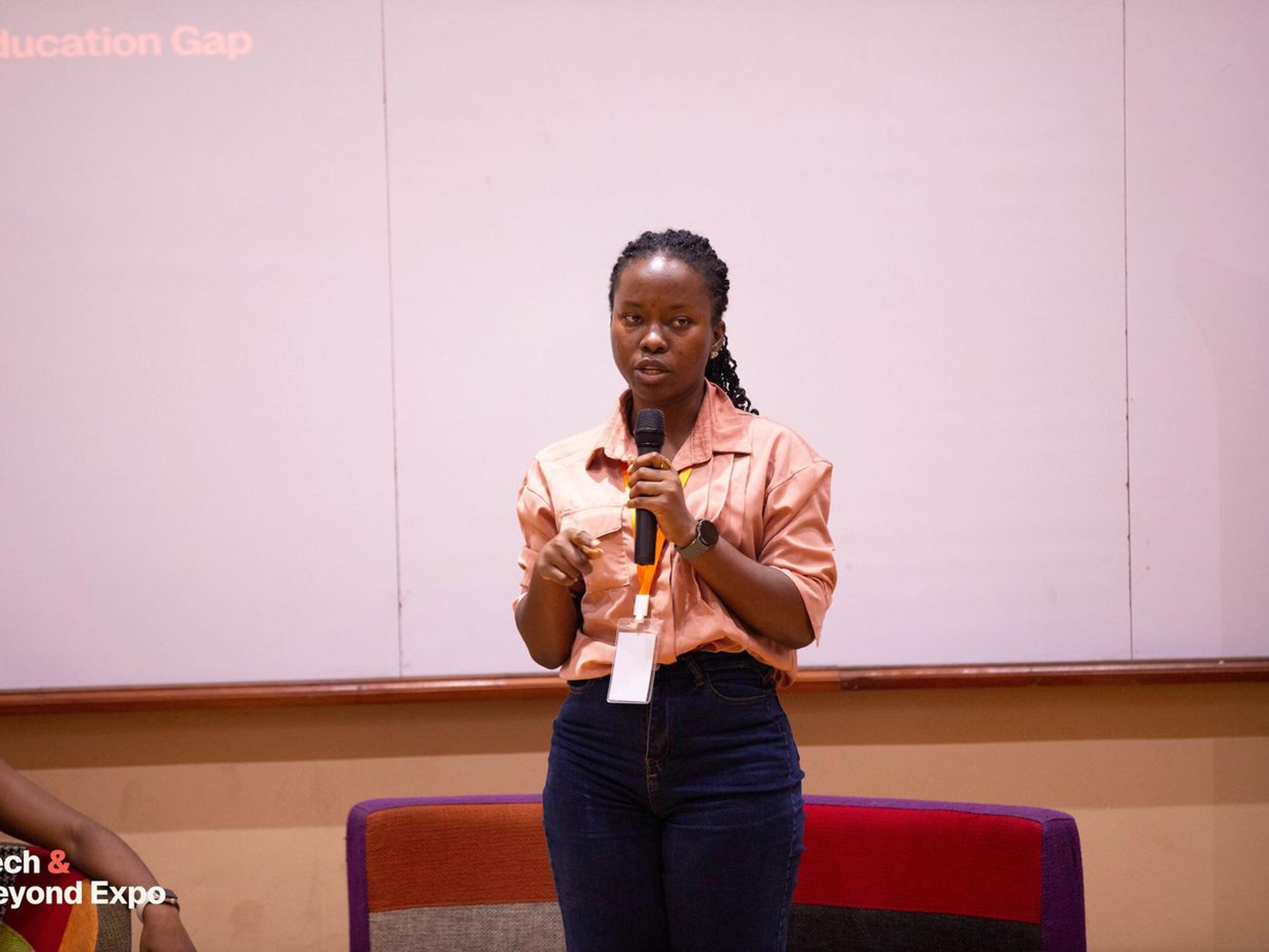 A panellist speaking with a microphone