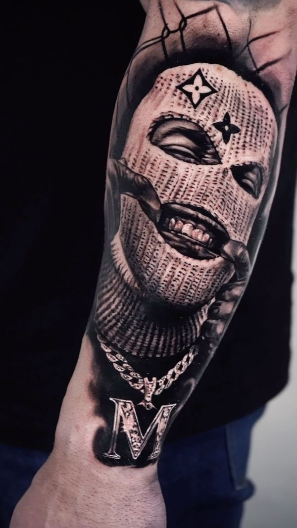 masked face, chain, letter M pendant